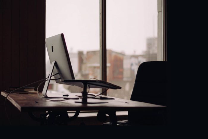 Photo of Desk, laptop and empty chair
