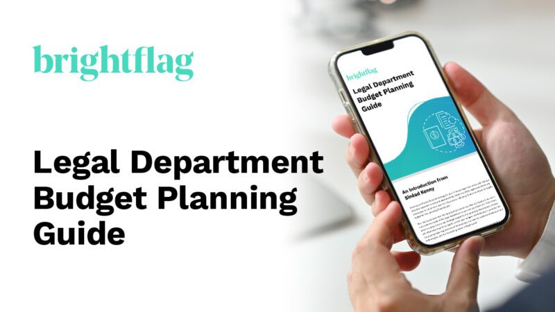 An image of a person's hands holding a phone, with Brightflag's Legal Department Budget Planning Guide on the screen, to the right of the resource title: Legal Department Budget Planning Guide.