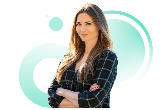 Anna Richards, Head of Community at Brightflag and host of the In-House Outliers legal operations podcast, smiling with arms folded in a plaid business suit in front of a white background.